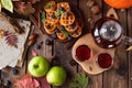 Many waffles are stacked on a plate, decorated with mint leaves and blueberries. Tea in a glass teapot and two small bowls Royalty Free Stock Photo