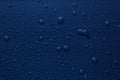 Many water drops on bright blue background Royalty Free Stock Photo