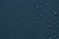 Many water drops on dark dusty blue background Royalty Free Stock Photo