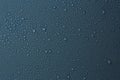 Many water drops on dark dusty blue background Royalty Free Stock Photo