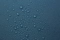 Many water drops on dark dusty blue background Royalty Free Stock Photo