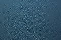 Many water drops on dark dusty blue background Royalty Free Stock Photo