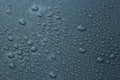 Many water drops on dark dusty blue background, closeup Royalty Free Stock Photo