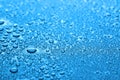 Many water drops on dark dusty blue background, closeup Royalty Free Stock Photo