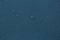 Many water drops on dark dusty blue background Royalty Free Stock Photo