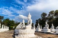 Many white buddha statues sitting in row in thai temple Royalty Free Stock Photo