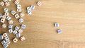 Many white dice with red and blue dots on wooden table. Casino gambling concept. Close-up Royalty Free Stock Photo