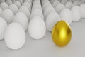 White eggs in a row with one golden egg Royalty Free Stock Photo