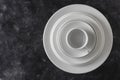 Many white empty plate and cup on black background, close up Royalty Free Stock Photo