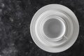 Many white empty plate and cup on black background, close up Royalty Free Stock Photo