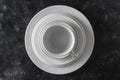 Many white empty plate and cup on black background, close up Royalty Free Stock Photo