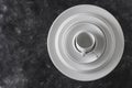 Many white empty plate and cup on black background, close up Royalty Free Stock Photo