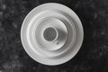 Many white empty plate and cup on black background, close up Royalty Free Stock Photo