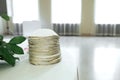 Many white gold-plated Jewish Kippa headdresses stacked on the table