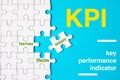 Many white jigsaw puzzle and KPI key performance indicator word on blue background - idea solution concept Royalty Free Stock Photo