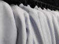 Many white shirts hanging from the clothes rack, Wedding dress rental