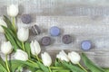 Many white tulips and gray macaroons on light wooden surface Royalty Free Stock Photo