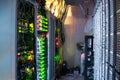 Many wires and computer equipment work in a dark server room. The server racks and the patch panel are in the data center