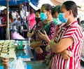 Many women are folded and waiting to grill bananas in the street market Royalty Free Stock Photo