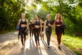 Many women with mats, group yoga training