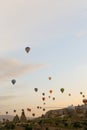 Many wonderful l hot air balloons flying over Cappadocia rocks in Turkey.