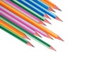 Many wood pencil crayons of different colors arranged in a wonderful line on a paper