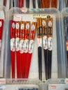 Many wooden chopsticks in a store. Decorative wooden chopsticks. Filled space with chopsticks. Chopsticks heap. Lot of