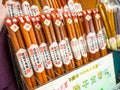Many wooden chopsticks in a store. Decorative wooden chopsticks. Filled space with chopsticks. Chopsticks heap. Lot of