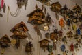 Many wooden classic carved clocks hanging on the wall, in the store