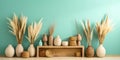 Many wooden frames and clay vases with pampas grass on wooden parquet floor near turquoise wall. Boho interior design