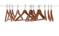 Many wooden hangers on a rod