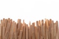 Many wooden ice cream sticks in chaotically row on white background isolated, flat lay bottom Royalty Free Stock Photo