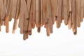Many wooden ice cream sticks in chaotically row on white background isolated, flat lay top Royalty Free Stock Photo