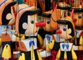 Many wooden Pinocchio puppets at a market