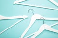 Many wooden white hangers on blue background Royalty Free Stock Photo