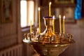 Many yellow candles stand in the old church. Christianity. Burning candle Royalty Free Stock Photo