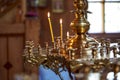 Many yellow candles stand in the old church. Christianity. Burning candle Royalty Free Stock Photo