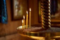 Many yellow candles stand in the old church. Christianity. Burning candle Royalty Free Stock Photo