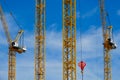 Yellow construction cranes on blue sky backgrounds Royalty Free Stock Photo