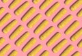 Many yellow corn cobs lie in a row on a pink background. Creative decorative composition. Modern Art. 3D rendering.