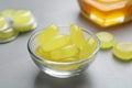 Many yellow cough drops on light grey table Royalty Free Stock Photo
