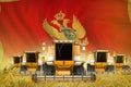 Industrial 3D illustration of some yellow farming combine harvesters on rural field with Montenegro flag background - front view,