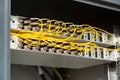 Many yellow fiber optic cables are inserted into the switches in multiple rows. Cable management. Horizontal orientation Royalty Free Stock Photo