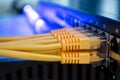 Many yellow internet wires connect to the network switch in the server room. Utp cable connects to the interfaces of the main