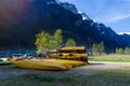 many yellow Kayak boats placing on the ground in Gudvangen