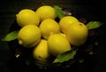 Many yellow lemons in a vase