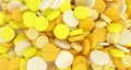 Many yellow pills close-up