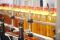 Many yellow plastic bottles with fresh beer go on conveyor Royalty Free Stock Photo