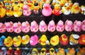 So many yellow rubber ducks for the bathroom. sales items on display, toy animals disguised with many different types of clothes