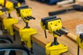 Many Yellow Vises are Set on the Work Bench at the School. Royalty Free Stock Photo